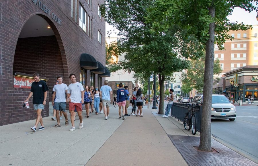 A group of students walk down Green Street without masks on Aug. 21. More than 1,200 people have tested positive for COVID-19 in the first two weeks of school.  