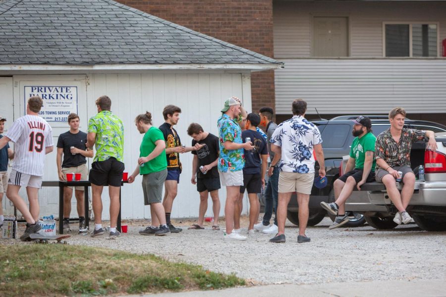 Students party in the driveway of a house located on First Street on Aug. 28. Some on campus residents received court notices due to breaking social distancing measures.  The students pictured are not necessarily those that received court notices.