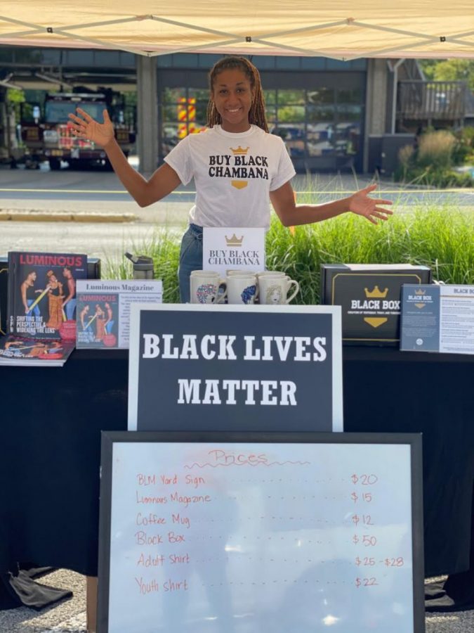 Mariah Madison stands at a Buy Black Chambana pop-up shop in August. Madison’s blog sponsors Black-owned businesses within the Champaign-Urbana area.