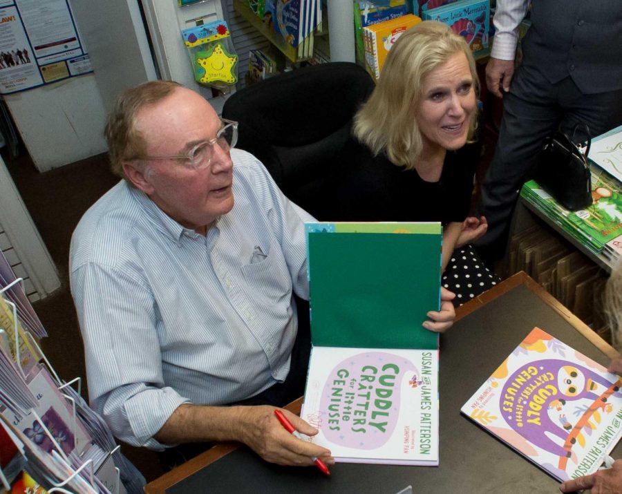 Best-selling author James Patterson signs a book for a fan inside Classic Bookshop during 2018 in Palm Beach, Florida. Columnist Noah argues Patterson has earned the title of a literary hero.