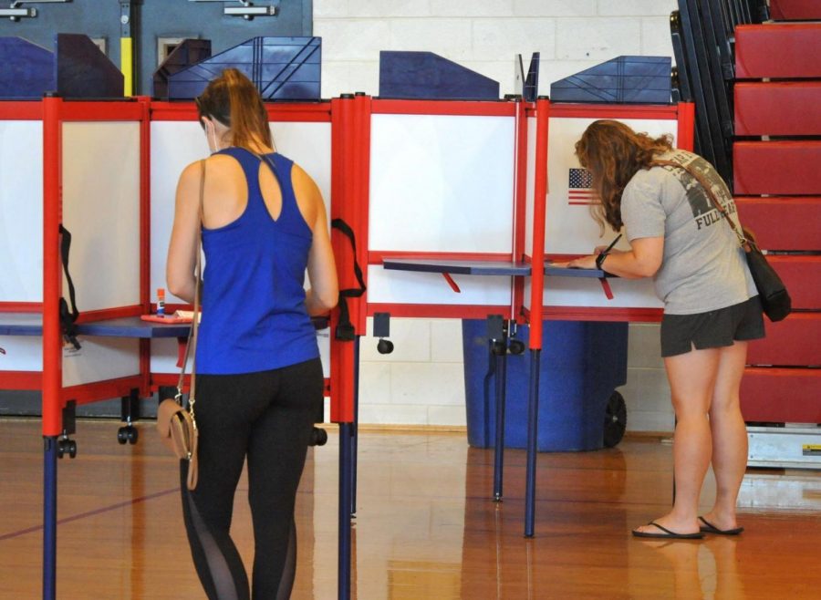 Socially distanced voters mark their ballots during early voting for the state primary at North Quincy High School in Quincy, Massachusetts on Aug. 22. 