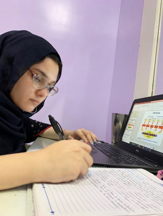 Sarah Kishta looks over lecture slides at 2:15 a.m. from her home in Zagazig, Egypt. Kishta has had to adapt to virtual classes through a seven hour time zone difference. 
