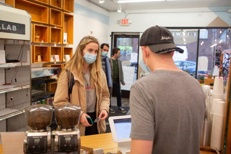 BrewLab General Manager Gab Wikoff serves a customer on Tuesday afternoon. The coffee shop, along with other similar businesses in the area, have had to adapt to the COVID-19 pandemic.
