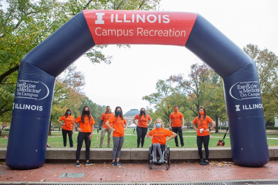 Organizers and participants of the Futures So Bright 5k stand underneath the finish arc outside the Illini Union on the Main Quad on Wednesday. 