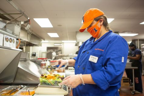 A FSHN 340: Food Production and Service student prepares a salad while working at the Bevier Cafe located in Bevier Hall on Friday. The Bevier Cafe has recently established its “Everybody Eats” initiative to fight food insecurity.
