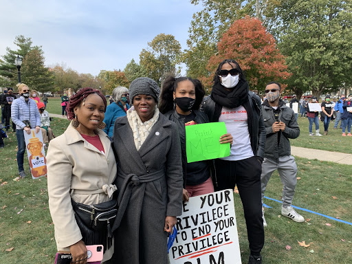 Illinois 103rd State District Representative Carol Ammons poses with supporters at the CU Womens March and Rally in West Side Park on Saturday.