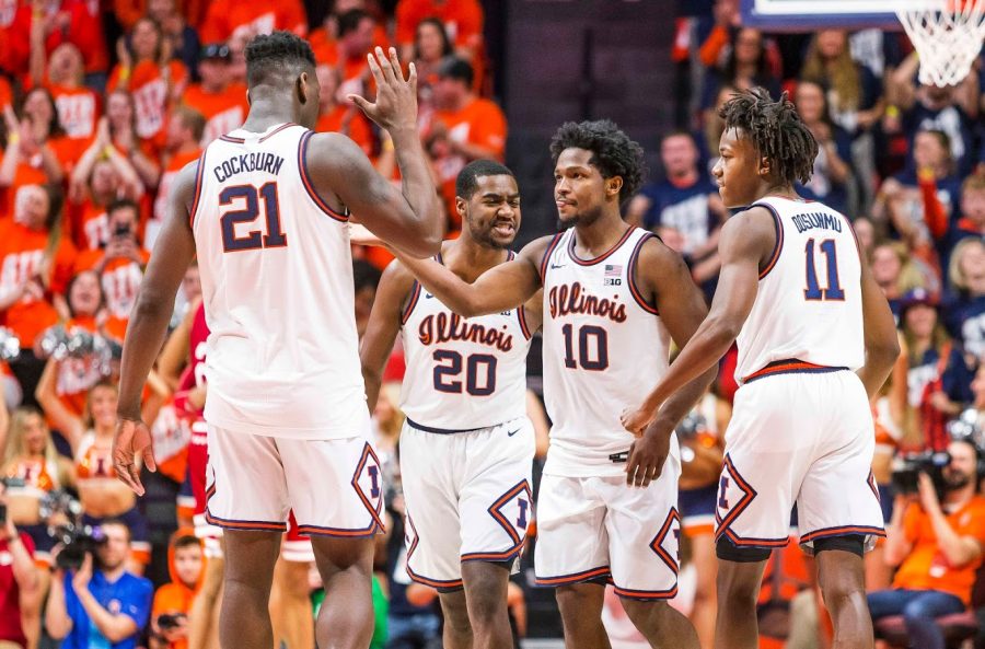 The Illinois mens basketball team celebrates a successful play during the game against Indiana on March 1.