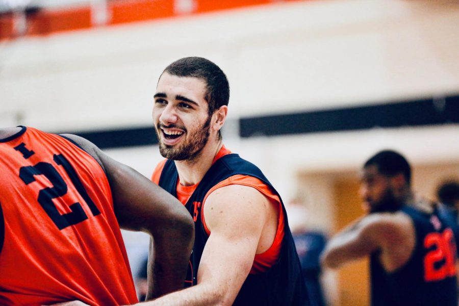 Junior Giorgi Bezhanishvili pats teammate Kofi Cockburn on the back during the first day of basketball practice on Wednesday.