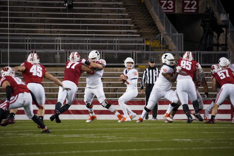 Illinois offensive line blocks Wisconsin in the game in Madison Friday night. Since then, 12 Badgers have tested positive for COVID-19, shutting down team activities. 