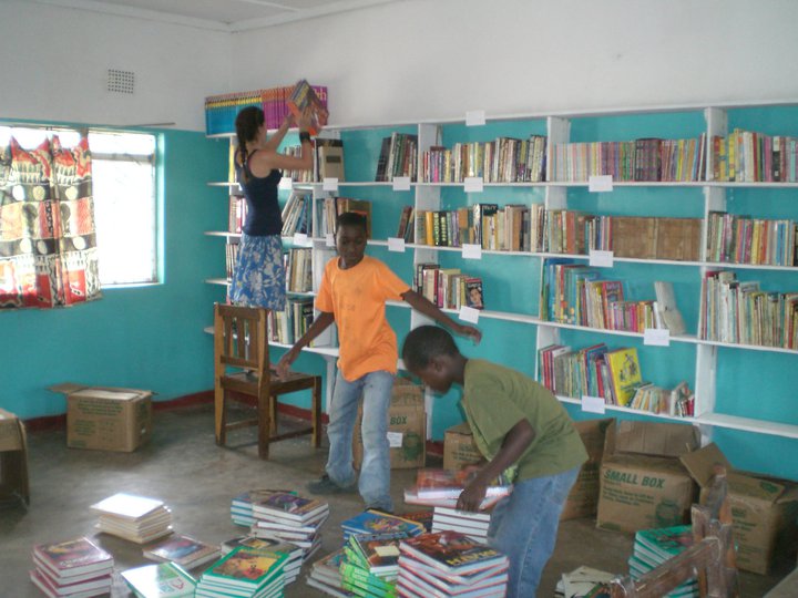 University alumna Nicole Musumeci helps shelve textbooks at the Chadiza Basic Library near her host village, Robi, in Zambia.