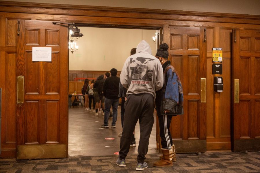 The last of voters wait in line after entrances have closed at the University YMCA polling place on Tuesday night.
