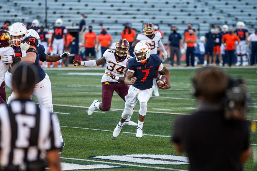 Sophomore quarterback Coran Taylor slips through an opening in the defense during the game against Minnesota on Nov. 7.