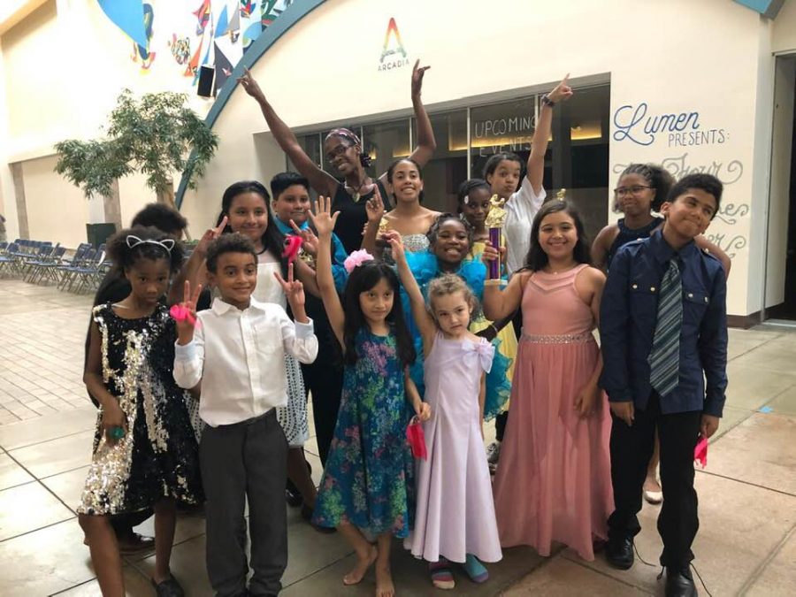 Ja Nelle Davenport-Pleasure poses with the group of kids she taught to ballroom dance at the Lincoln Square Mall, on Aug. 18, 2019.