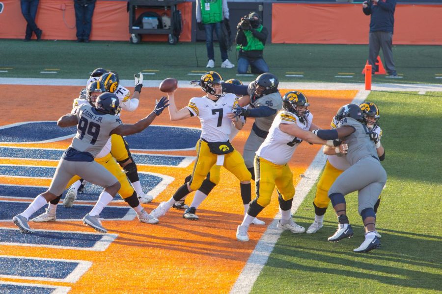 Roderick Perry and Owen Carney Jr. get pressure on Iowas quarterback Spencer Petras in Illinois game against Iowa on Saturday. The Illini lost to the Hawkeyes 35-21.