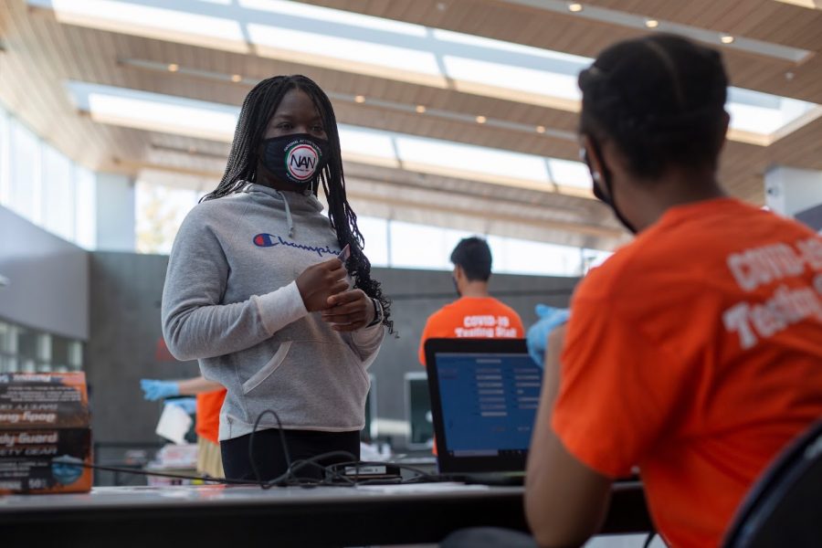 Jessica Osemwngie checks in at the COVID-19 testing site at State Farm Center on Oct. 9. The University’s COVID-19 protocols were widely praised after the campus saw no hospitalizations or deaths in the fall.