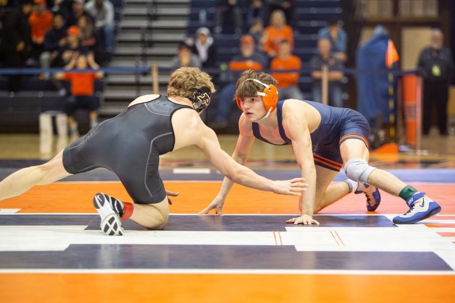 Sophomore+Justin+Cardani+grapples+with+his+opponent+during+the+wrestling+meet+against+Purdue+on+Feb.+16%2C+2020.