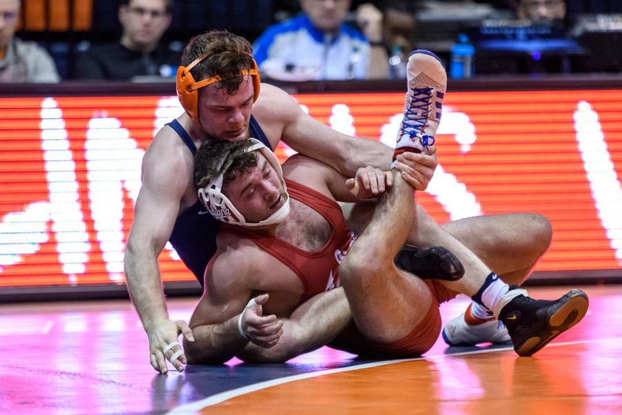 Redshirt sophomore Danny Braunagel pins an opponent at a previous match. Braunagel helped secured the win against Indiana at the meet on Saturday.