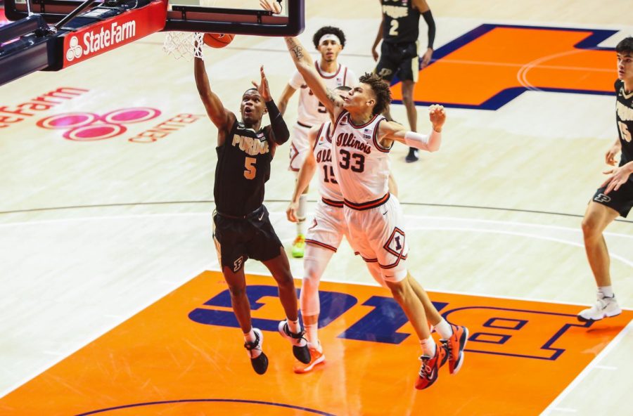 Forward basketball player Coleman Hawkins reaches up to block a shot against Purdue on Jan. 2 at State Farm Center.