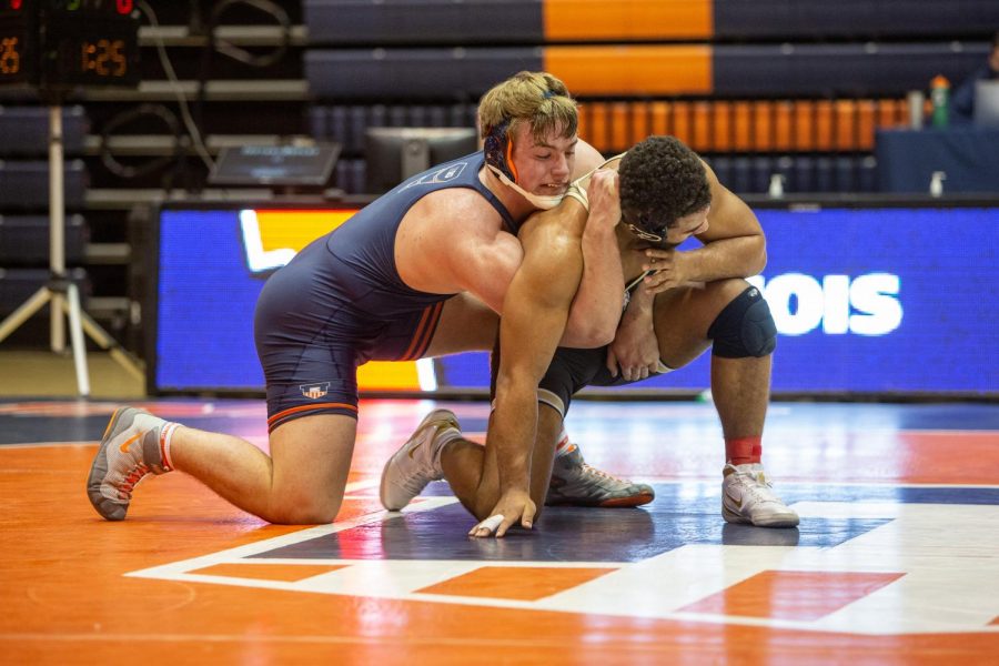 Sophomore Luke Luffman locks his opponents arm during the match against Purdue on Friday. The Illini won the match 19-17.