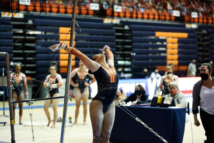 Sophomore Mia Takekawa poses after finishing a routine during the meet against Michigan on Sunday. Illinois lost the meet 197.375-196.650.