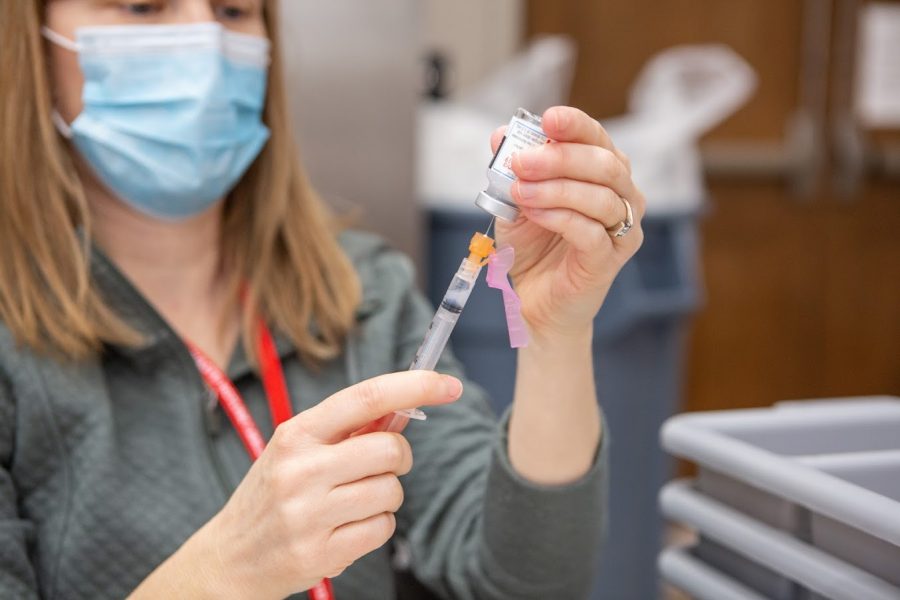 A pharmacist fills needles with the Moderna COVID-19 vaccine at the I-Hotel on Feb. 11. A walk-in vaccine clinic will open at Church of the Living God on Saturday.