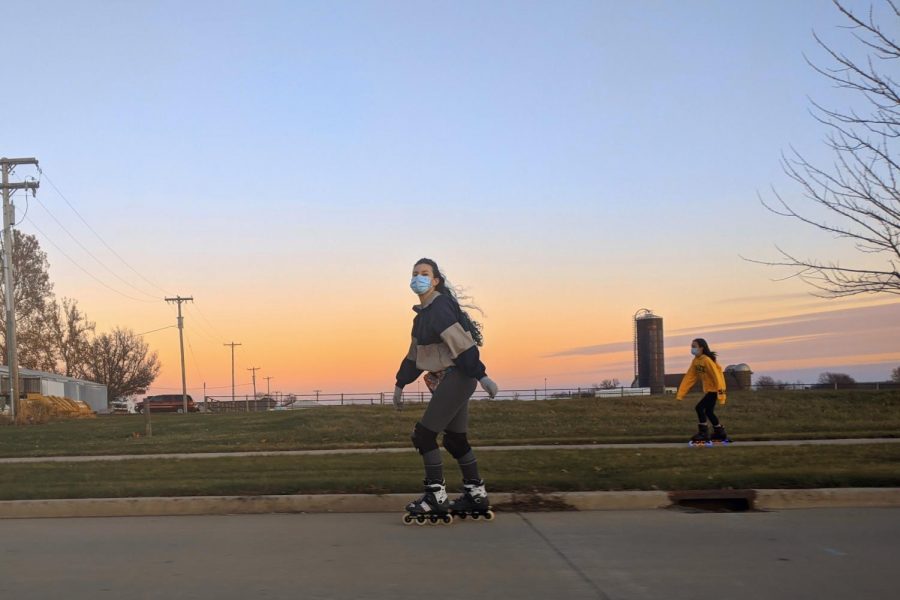 Students Hanna Fei and Francis Coulter skate down South Fourth Street near Horse Research Farm during an Inline Insomniacs skate on Dec. 4, 2020.