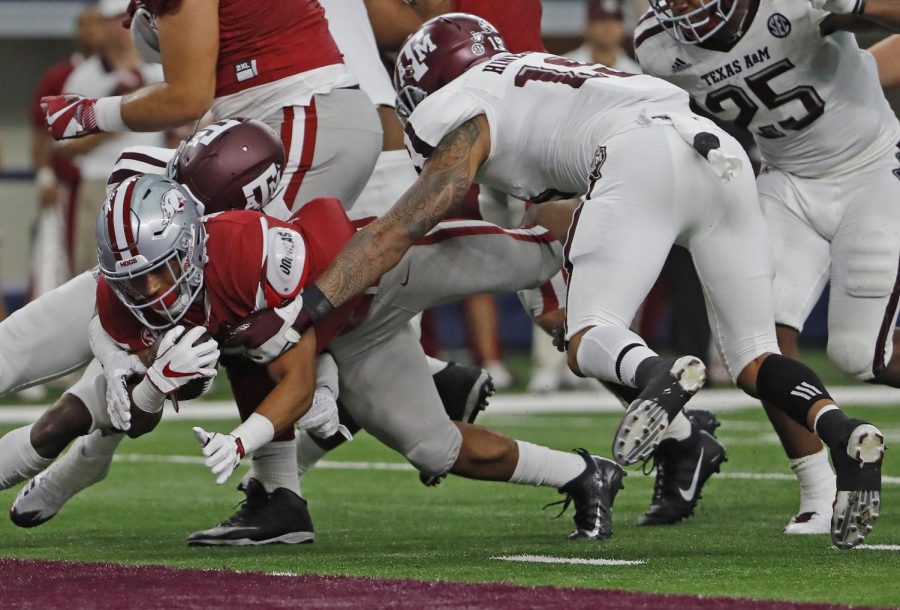 Arkansas Razorbacks running back Chase Hayden dives in to the end zone for a second quarter touchdown against the Texas A&M Aggies on Sept. 23, 2017 in the Southwest Classic. Hayden has recently joined the Illinois football team for the 2021 season.