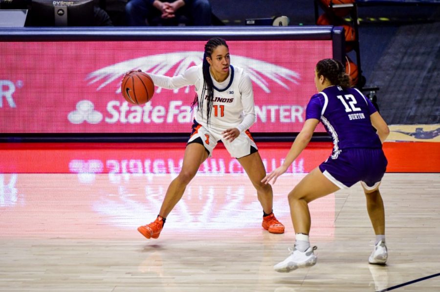 Sophomore+Jada+Peebles+attempts+to+evade+a+defender+during+the+game+against+Northwestern+on+Wednesday.+The+Illini+lost+the+game+67-61.