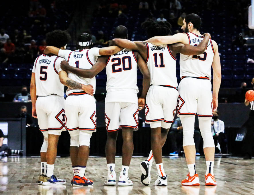 The Fighting Illini Men’s Basketball team links arms during the Big Ten Tournament matchup against Iowa on Saturday at Lucas Oil Stadium in Indianapolis, IN. The Illini are entering the NCAA tournament for the first time in eight years. 