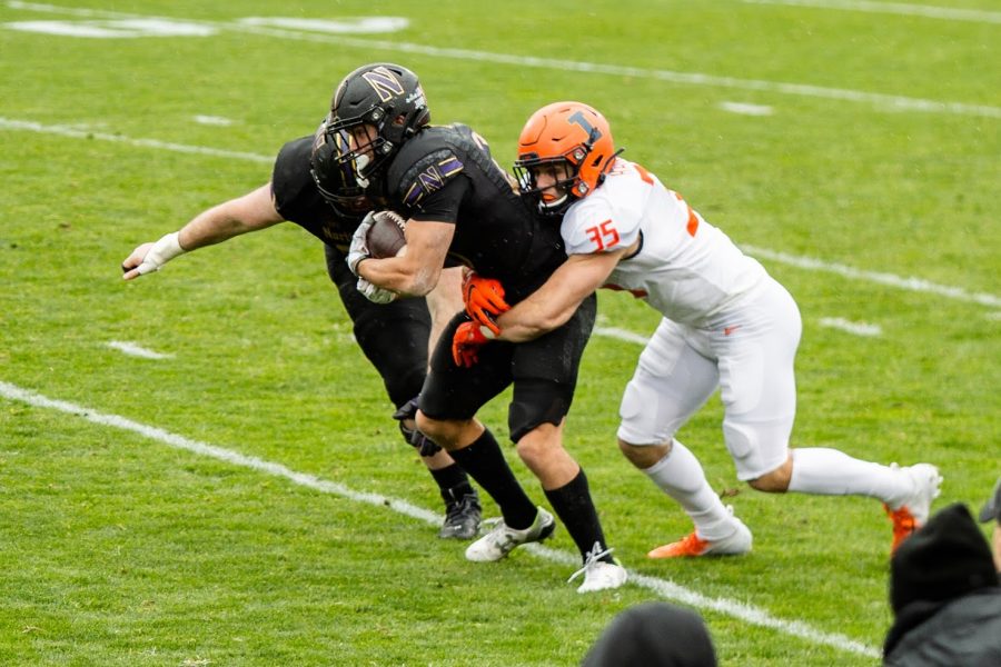 Senior Jake Hansen tackles the opposing ball carrier during the game against Northwestern on Dec. 12. Hansen has decided to return to the Illini for a sixth season.