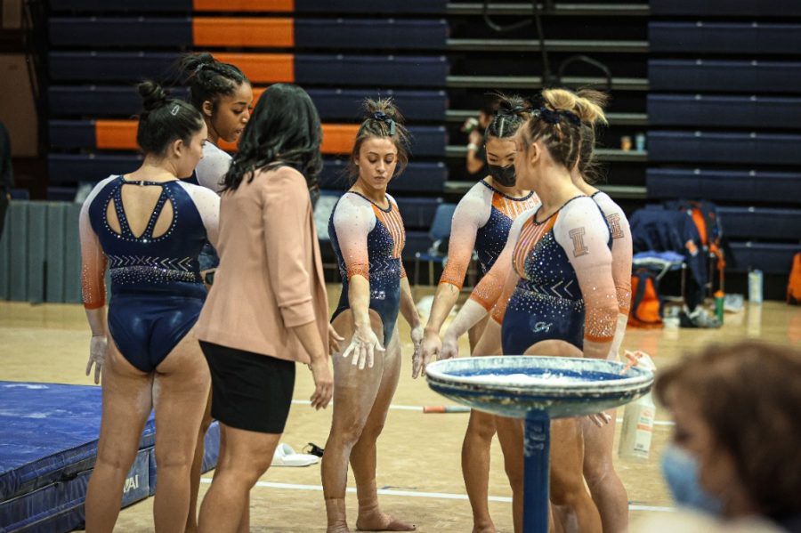 The+Illinois+womens+gymnastics+team+huddles+up+before+the+meet+against+Michigan+on+Feb.+21.+The+team+lost+to+Iowa+on+Sunday.