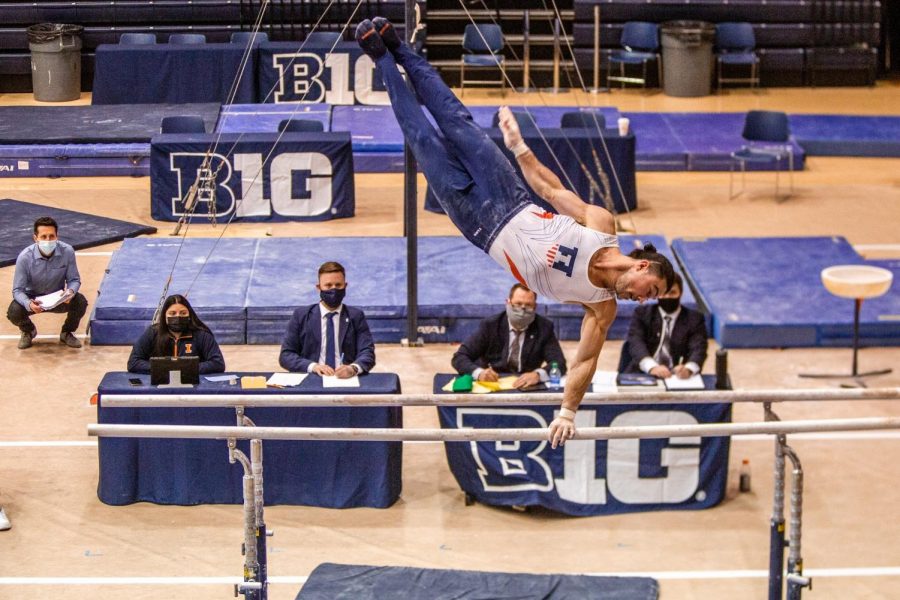 Junior Clay Stephens poses on the parallel bars during their meet on Jan. 23. The mens team continues to practice and work on their skills before the NCAA Mens Gymnastic tournament. 