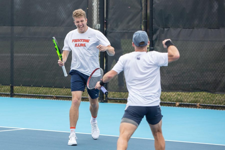 Redshirt junior Alex Clark and senior Zeke Clark celebrate after winning a point against Michigan on Friday. The Illinois men’s tennis team will face Wisconsin and Minnesota this weekend as they move closer to competing for tournament titles.
