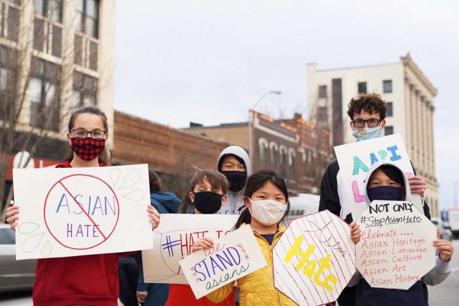 A group of kids hold signs displaying phrases such as “#StopAsianHate” and “We Stand Asians” at a protest in downtown Champaign on March 30.