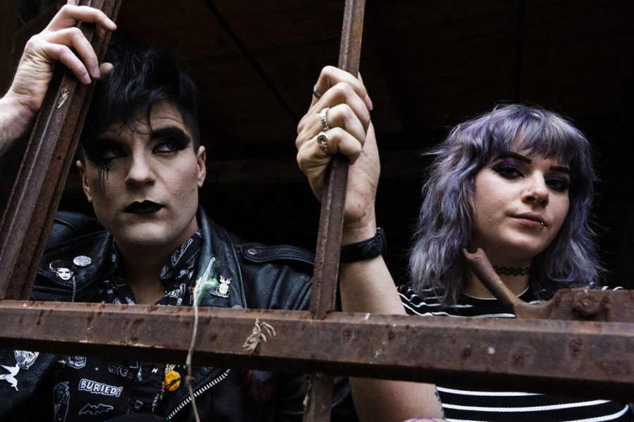 Members of the band “Vision Video” Dusty Gannon and Emily Fredock pose for a photo. The band connects with listeners on a personal level through their gothic-style rock music.  