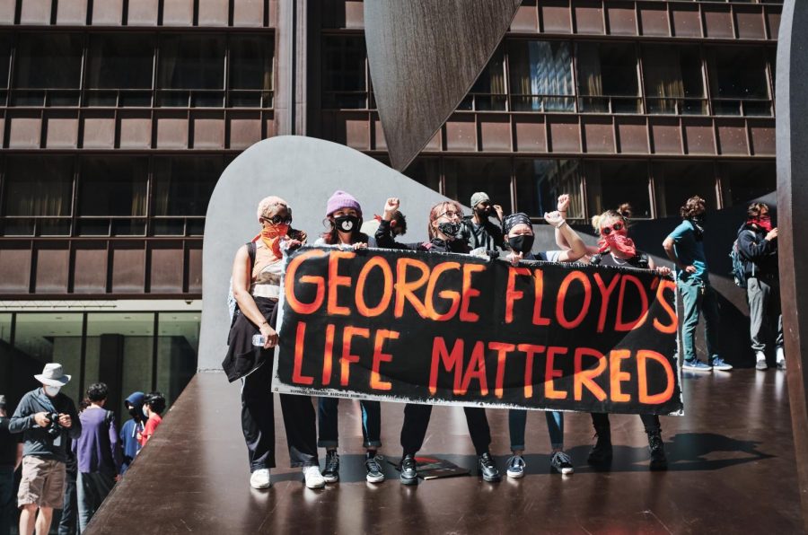 A group of protestors hold a sign reading “George Floyd’s Life Mattered” in downtown Chicago on May 30. The University recently sent a Massmail to students after Derek Chauvin was convicted of murder calling for the public to take action against  systemic racism.