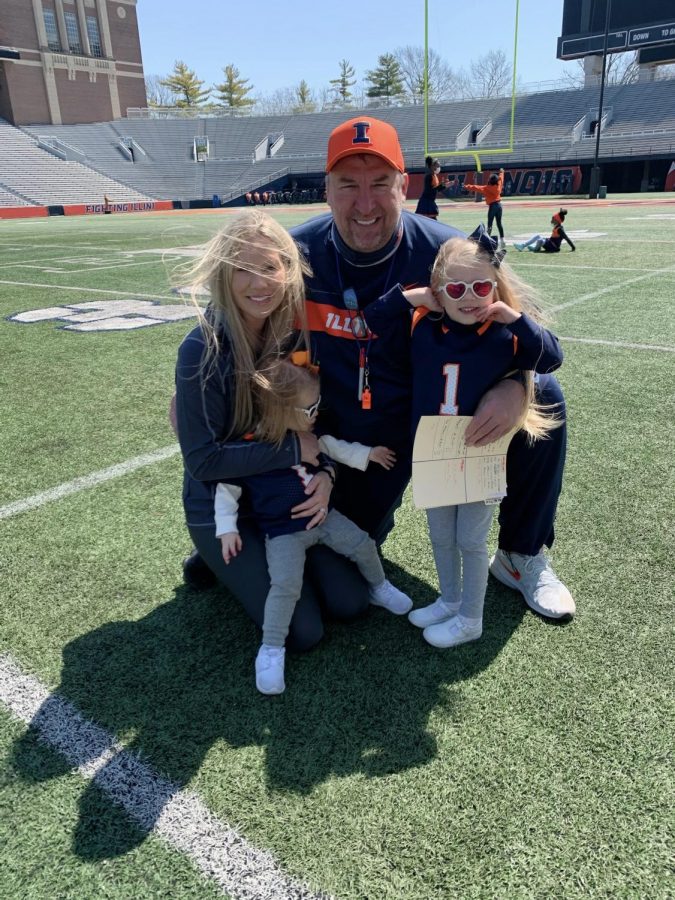 Bret Bielema poses for a photo with his girls on the field at Memorial Stadium on Saturday.