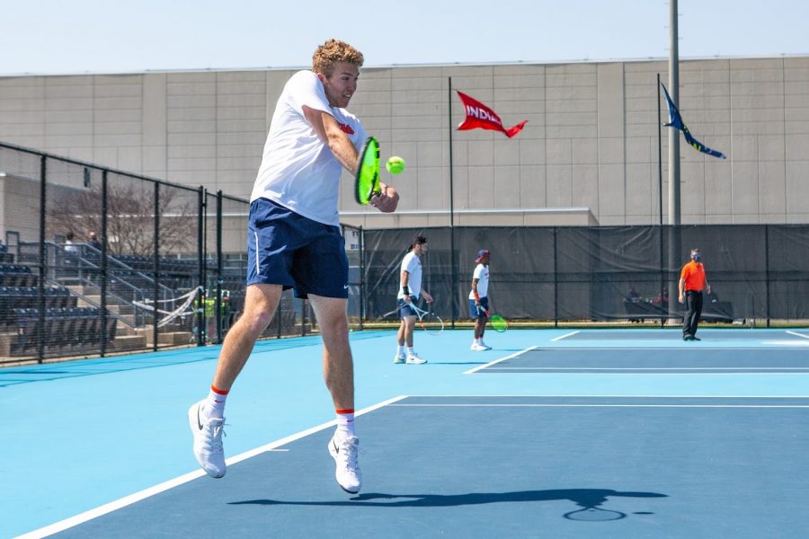 Junior Alex Brown hits the ball while competing against Minnesota on April 4. The Mens Tennis team hopes to continue their winning streak for their upcoming games. 