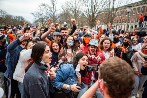 A group of University students crowd around a videographer on the Main Quad after the Illini basketball team won the Big Ten Championship on March 14. Columnist Nick Johnson argues that Illini basketball fans shouldn't be worried for next season because Brad Underwood is prepared to build another winning team.