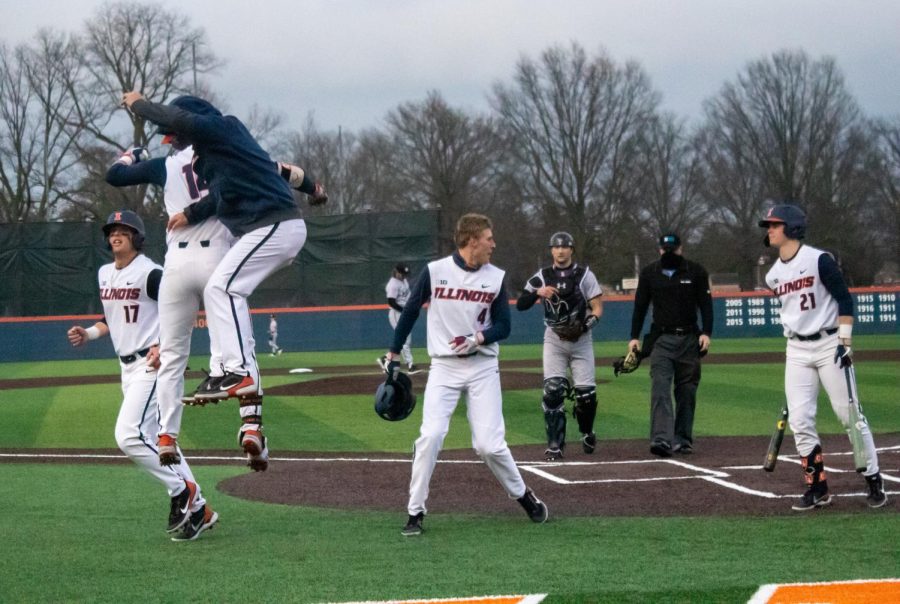 The Illinois baseball team celebrates after coming off the field during a game against Northwestern on March 26. The team is preparing to host Nebraska this weekend at Illinois Field. 