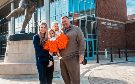 Illinois head football coach Bret Bielema and his wife Jen Bielema pose for a photo with their daughters Briella and Brexli in front of the Henry Dale and Betty Smith Football Center on Dec. 12. The Bielema family hopes to reside in Champaign for a long time.