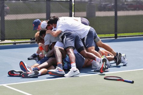 Communications
The Illinois men’s tennis team celebrates on the court after winning the Big Ten tournament Sunday.
