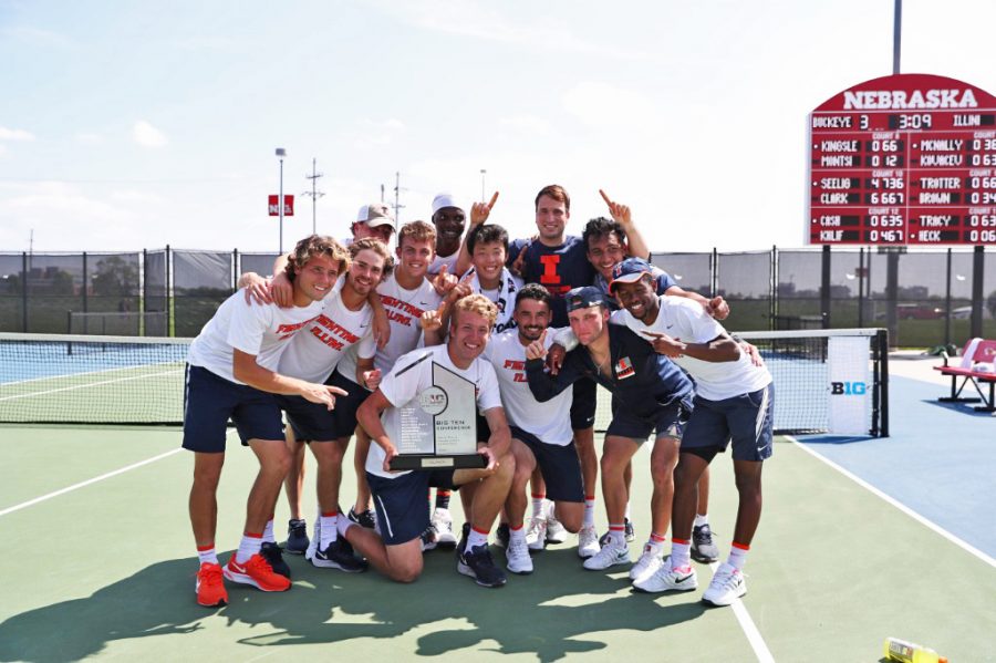 The Illinois men’s tennis team poses for a photo with the trophy they received for winning the Big Ten Tournament in Lincoln, Nebraska Sunday.