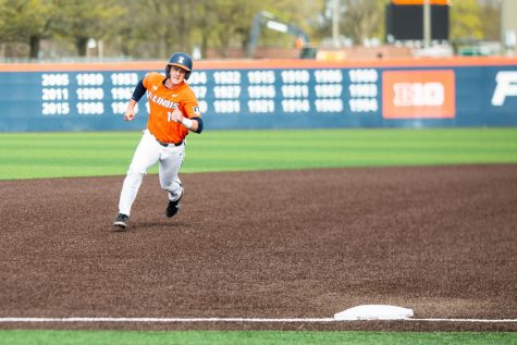 Senior Jackson Raper rounds second base and attempts to reach third during the game against Purdue. The Illinois baseball team closed out their final homestand with a series win over Penn State.