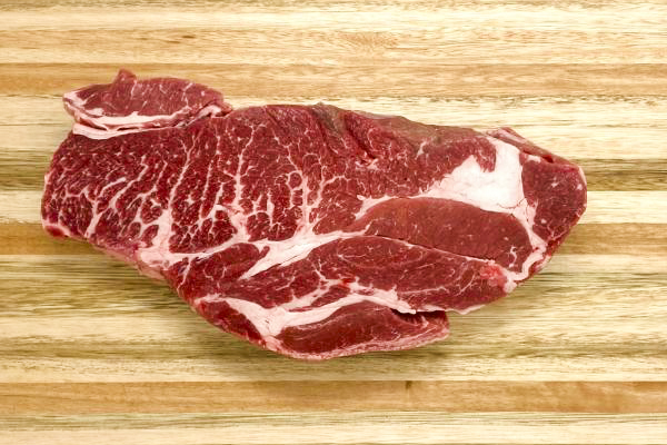 A frozen boneless beef chuck roast sits on a wooden cutting board in the Universities Meat Science Lab. The lab supplies local residents with different kinds of products that are harvested from the University farms south of campus.