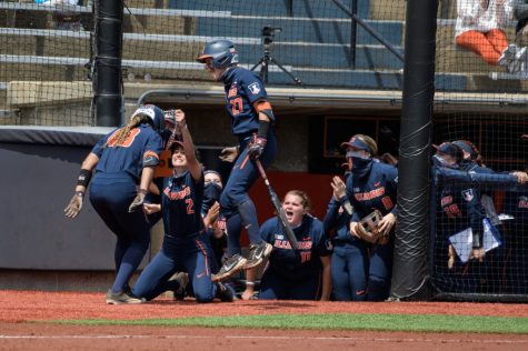 Illinois softball players celebrate Jaelyn Vickery during the game against Ohio State May 8. The team reflects on a successful season with multiple accolades amidst the pandemic. 