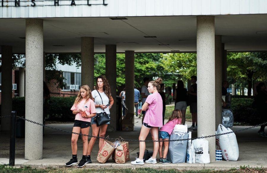 A student waits outside of Hopkins Hall with her family on Aug. 22, 2019 for move in day. College freshmen should utilize advice from current students before starting college in the fall. 