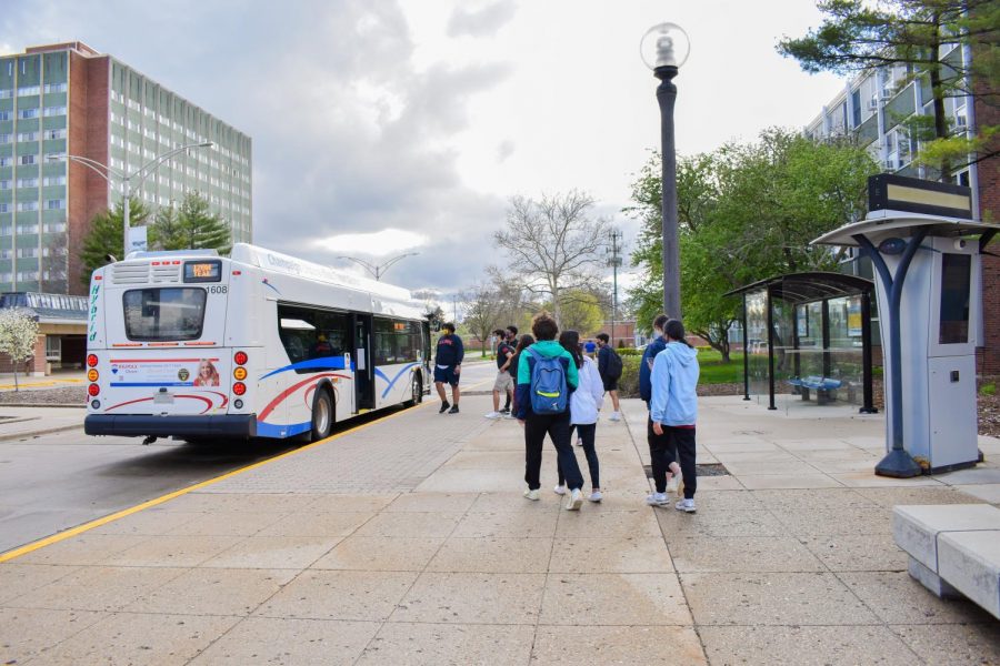 University students board a CUMTD bus next to Florida Avenue Residence Hall on April, 11. Champaign-Urbana Mass Transit District continues their expansion project at Illinois Terminal. 