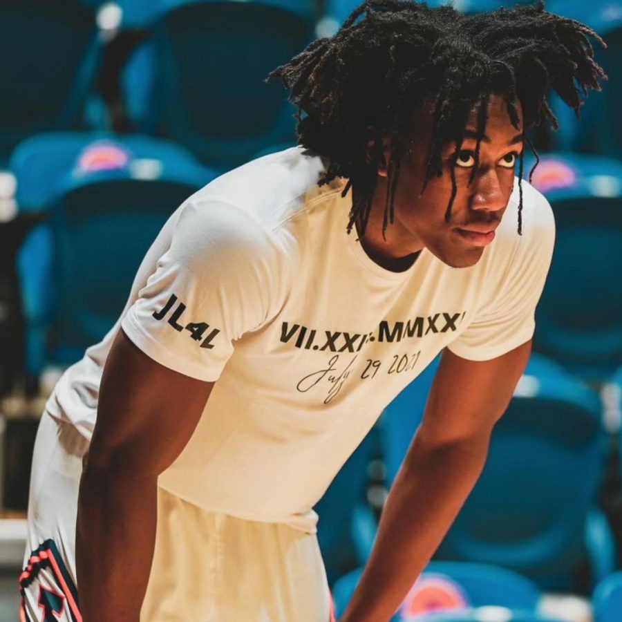 Former Illinois basketball player Ayo Dosunmu stands on the basketball court watching the plays. Ayo met with NBA team during the NBA Draft Combine.