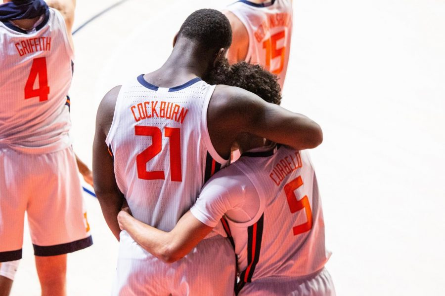 Kofi Cockburn (21) embraces Andre Curbelo (5) during the game against Nebraska at State Farm Center on Feb. 25. Cockburn announced Friday that he will be returning to Illinois for his junior season.